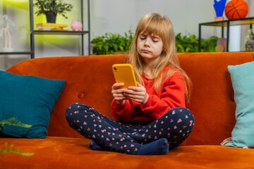 Child girl use smartphone, playing game, loses becoming surprised sudden lottery results, bad news,...
