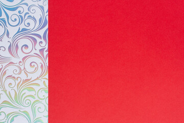 iridescent paper with floral swirls and blank red paper for copy