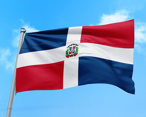 Dominican Republic flag fluttering in the wind on sky.