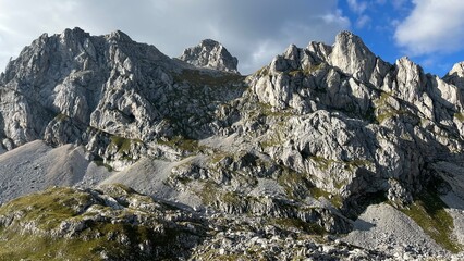 Fototapeta na wymiar Panoramic view of the Dolomites mountain peaks. Massive sharp and high stone wall in the Alps in Europe