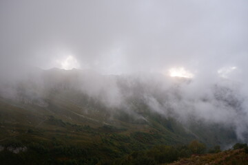 Mountain peak in fog, fog shrouded a mountain peak, natural landscape