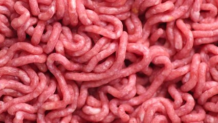 Minced meat, beef mince, forcemeat, fresh raw uncooked ground meat close up, rotating background. Flat lay. 