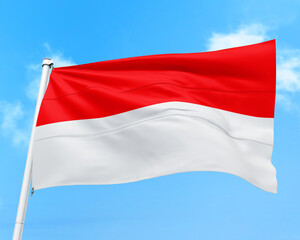 Indonesia flag fluttering in the wind on sky.