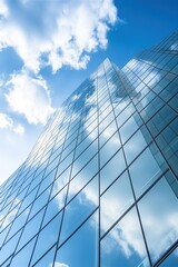 Blue glass skyscraper reflecting clouds