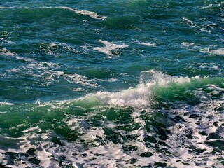 Corniglia, 5 Terre, Italy - January 05, 2024: Beautiful photography of the Cinque Terre landscape. Spectacular  view of the waves with blue sky in the background in winter days. 