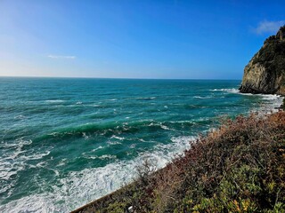 Corniglia, 5 Terre, Italy - January 05, 2024: Beautiful photography of the Cinque Terre landscape. Spectacular  view of the waves with blue sky in the background in winter days. 