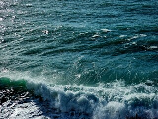 Corniglia, 5 Terre, Italy - January 05, 2024: Beautiful photography of the Cinque Terre landscape. Spectacular  view of the waves with blue sky in the background in winter days. 