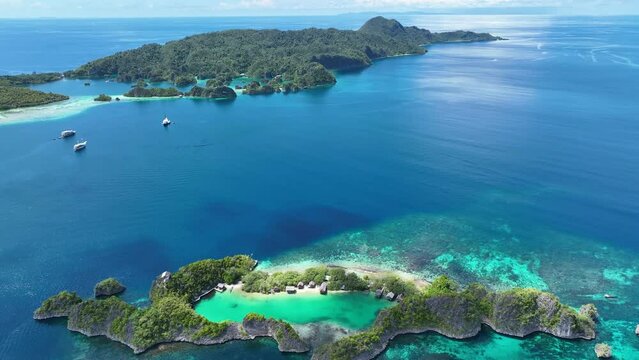 Rufas Island is fringed by beautiful coral reefs in Raja Ampat, Indonesia. This region is known for its exquisite coral reefs and overall high marine biodiversity.