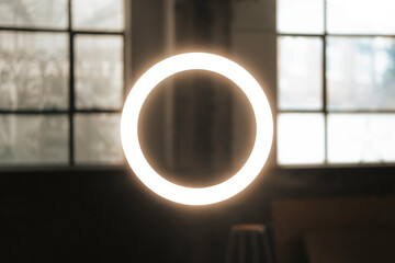 Floating circle halo ring light in and industrial warehouse building, abstract neon glowing light photography