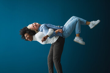 Interracial best friends laughing and having a good time together in a studio. Energetic young...