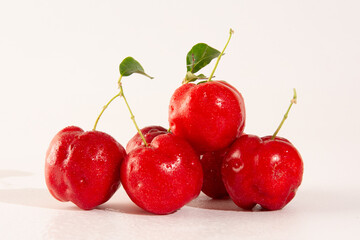 Freshly Harvested Organic Acerolas on a white table and clean background in front view