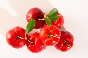 Freshly Harvested Organic Acerolas on a white table and clean background in top view