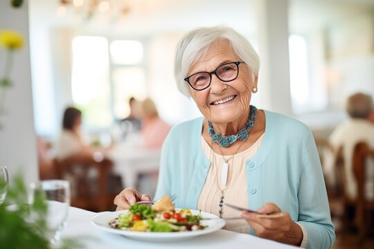 Smiling senior woman eating a healthy salad