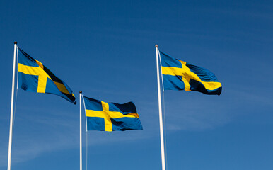 Celebrate Sweden: A Skyline Adorned with Three Fluttering Flags