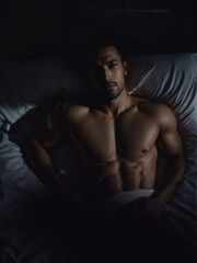 Man Lying in Bed Without Shirt, Relaxed and Comfortable. Generative AI.