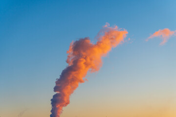 smoke in the sky coming from the chimney of the power plant