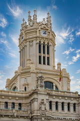 Fototapeta premium Architectural fragments of Cibeles Palace (Palacio de Cibeles) in Plaza de Cibeles: Madrid City Council (formerly Palace of Communication), iconic monument of the city. MADRID, SPAIN.