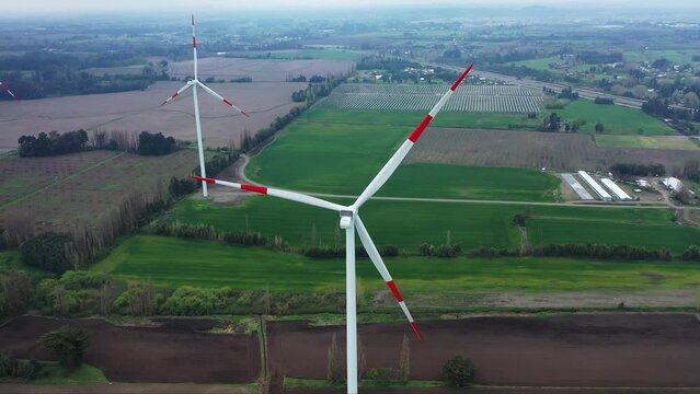 Close up of wind turbine. Aerial voew of wind mills farm park.