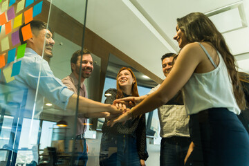 Obraz premium Happy and diverse group of businesspeople having fun together and working as a team