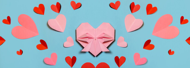 Pink paper hearts, origami, arranged on a light background. Concept for Valentine's Day. Mother's Day. Copy space.