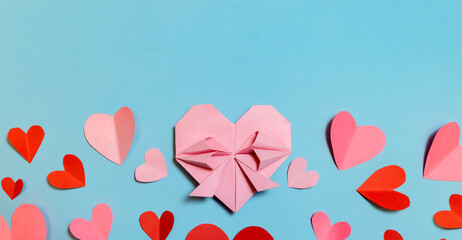 Pink paper hearts, origami, arranged on a light background. Concept for Valentine's Day. Mother's Day. Copy space.