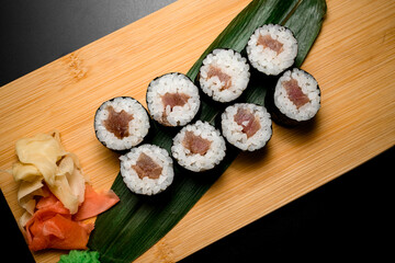 Portion of sushi rolls served on banana leaves top view