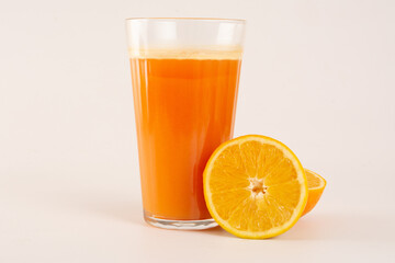 Fresh Organic Acerola and Orange Juice with sliced acerola and orange fruit in a glass cup in white...