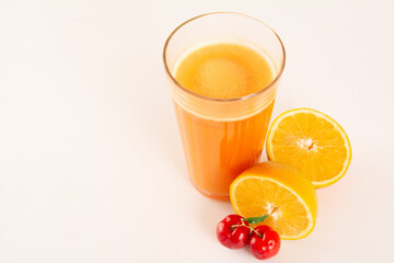 Fresh Organic Acerola and Orange Juice with sliced acerola and orange fruit in a glass cup in white background in top view