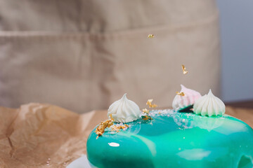 Modern French mousse cake with green mirror glaze. Picture for a menu or a confectionery catalog.