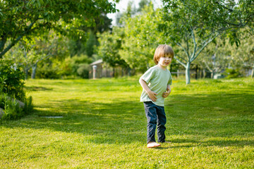Fototapeta premium Cute toddler boy playing outdoors on sunny spring day. Child exploring nature.