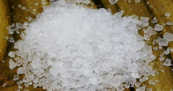 Macro video closeup of coarse grains of salt on a rotating plate