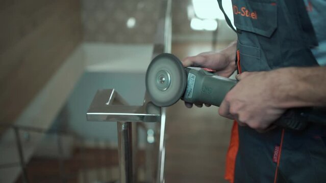 man worker polishing hand railing with polish instrument, handrail at building and constructions