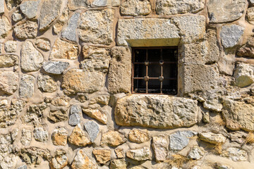Fototapeta na wymiar Window in an ancient fortress. Background with selective focus and copy space