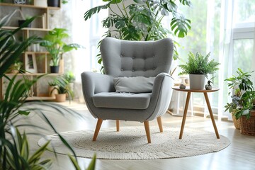 Cozy grey armchair with cushions and houseplants on tables in interior of light living room