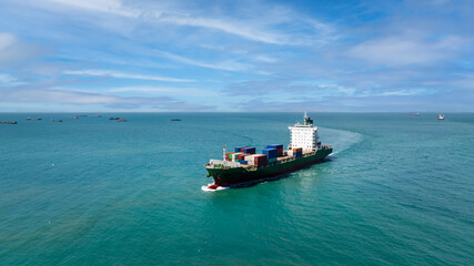 logistic cargo container ship sailing in sea to import export goods and distributing products to dealer and consumers across worldwide, aerial front view