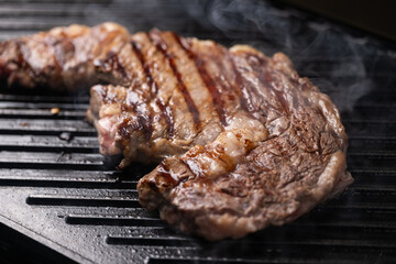 ribeye steak on hot smokey grill