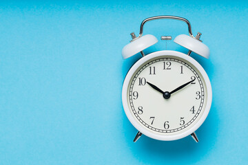 Classic Analog Alarm Clock on Blue Background, Time and Change Concept, Copy Space