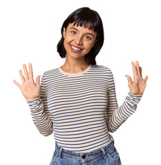 Young Hispanic woman with short black hair in studio showing number ten with hands.