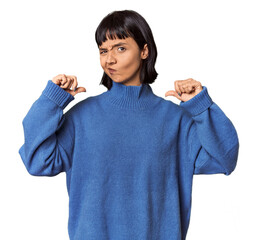 Young Hispanic woman with short black hair in studio feels proud and self confident, example to...
