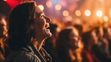 Fotobehang Woman laughing joyfully at a concert, surrounded by lights © Artyom