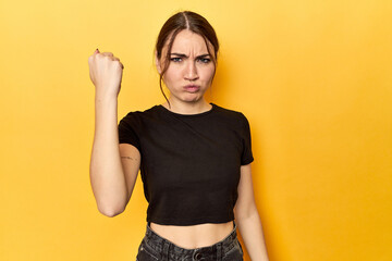 showing fist to camera, aggressive facial expression.