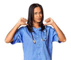 Young Filipina nurse posed in studio feels proud and self confident, example to follow.