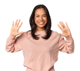 Young Filipina with long black hair in studio showing number ten with hands.