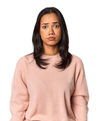 Young Filipina with long black hair in studio sad, serious face, feeling miserable and displeased.