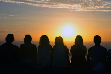 Fototapeta na wymiar Group of people looking at sunset