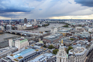 The aerial view of the River Thames and metropolitan area of London under the storm cloud
