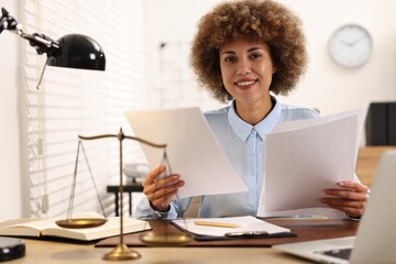 Happy notary with documents at workplace in office