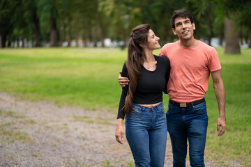 Couple in love walk embraced in the park