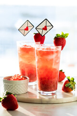Glasses of fresh strawberry lemonade with bubble pearls for Valentine's Day.