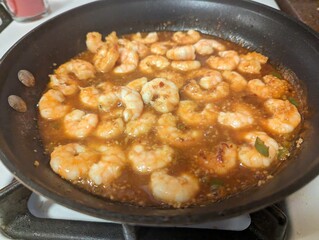 Pan of spicy garlic shrimp cooking